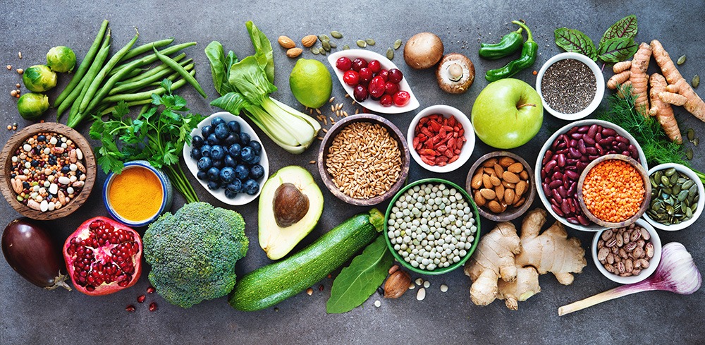 A wide array of healthy, whole foods. Fruits, vegetables, and legumes such as blueberries, pomegranates, broccoli, avocado, nuts and beans.