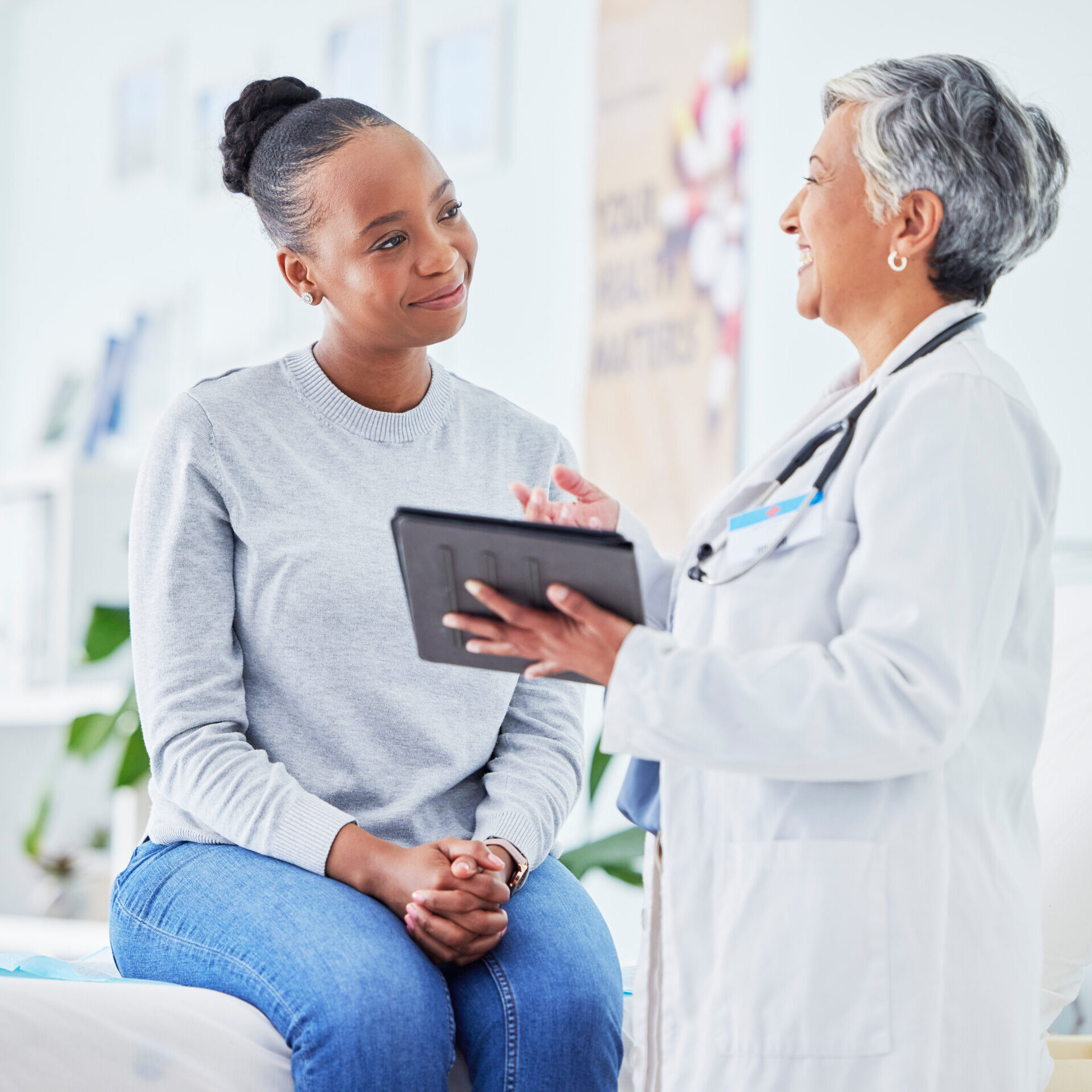 Doctor, women and tablet for happy healthcare, hospital news and support with test results or exam on bed. Senior nurse and patient with digital registration, clinic sign up and medical consultation.