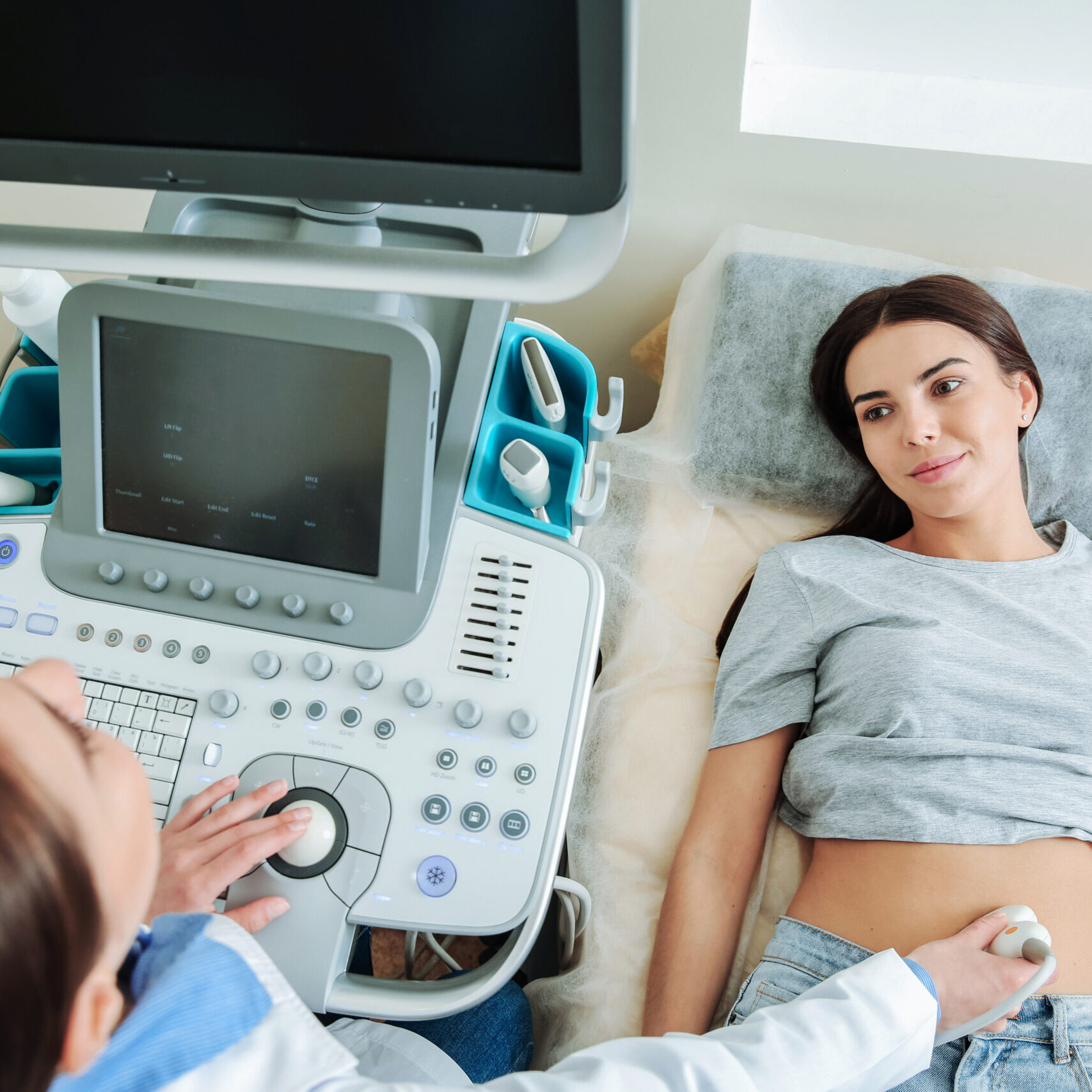 Woman undergoing ultrasound scan in clinic