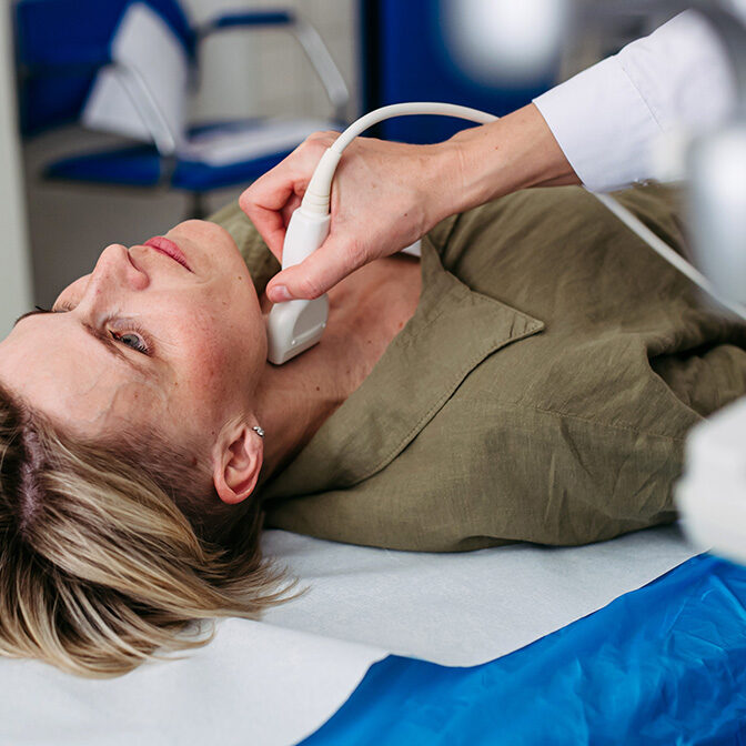 Female patient undergoing thyroid ultrasound examination. Lymp node sonography.