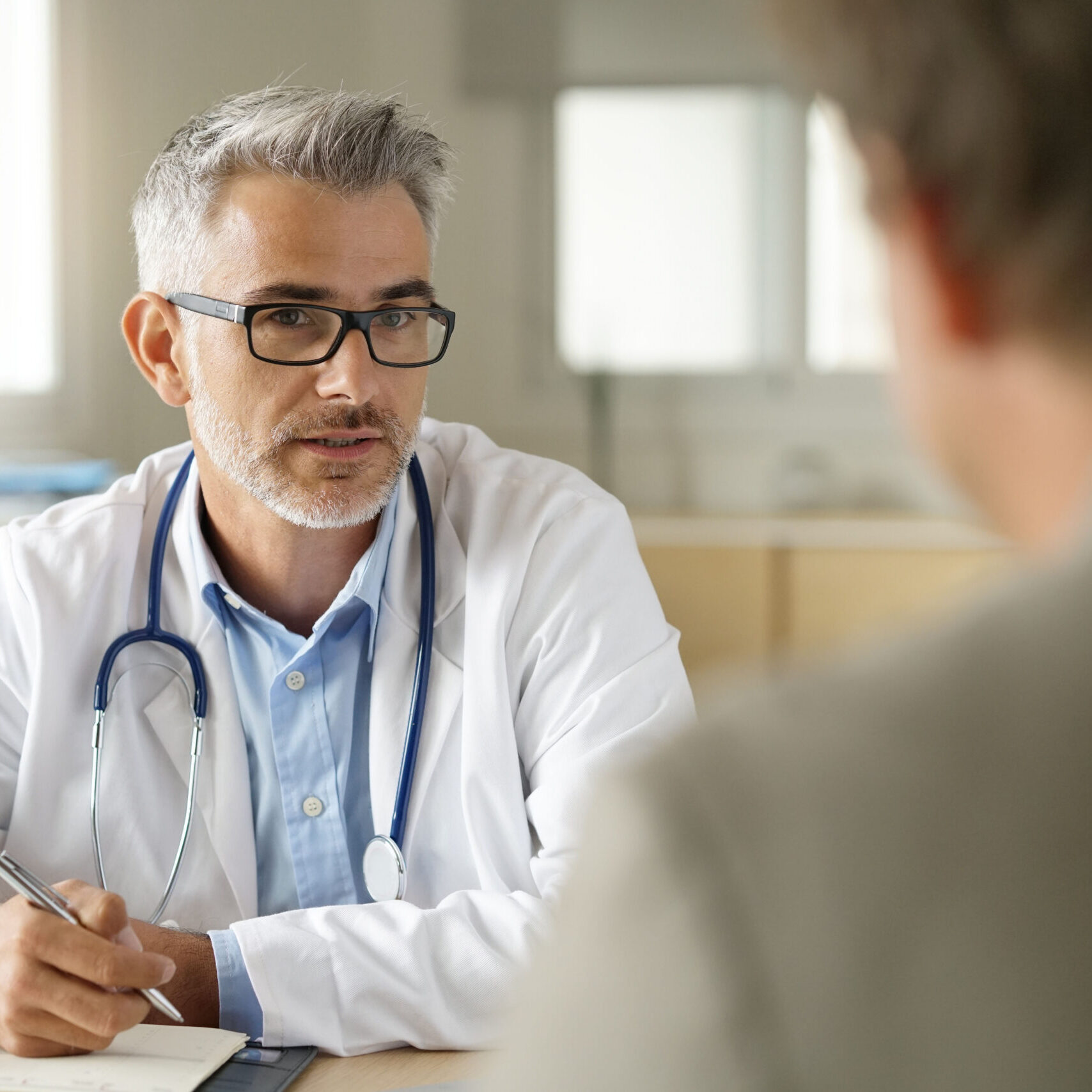 Doctor talking to patient in office