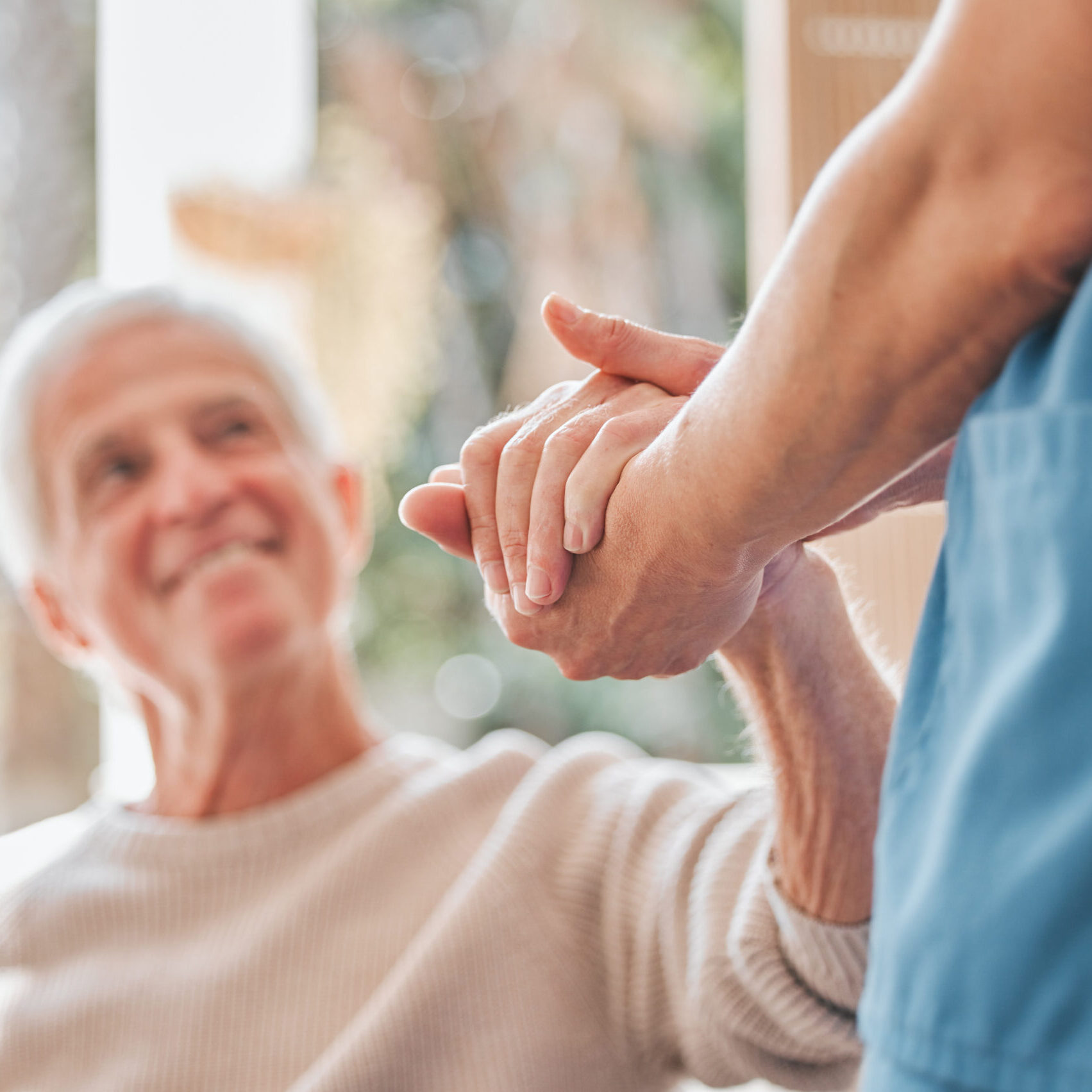 Shot of a nurse offering her elderly male patient support.
